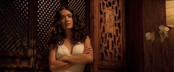 Movie still from “After the Sunset” (2004), directed by Brett Ratner – A beautiful woman standing in front of a wooden wall; Close Up shot, Low angle