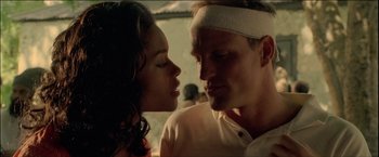 Movie still from “After the Sunset” (2004), directed by Brett Ratner – A man and a woman are kissing in a room; Close Up shot, Low angle