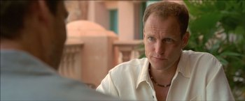 Movie still from “After the Sunset” (2004), directed by Brett Ratner – A person sitting at a table; Close Up shot, Over the shoulder angle