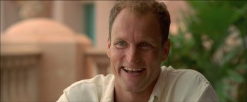 Movie still from “After the Sunset” (2004), directed by Brett Ratner – A person smiling for the camera; Close Up shot, Low angle