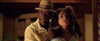 Movie still from “After the Sunset” (2004), directed by Brett Ratner – A man holding a gun next to a woman in a hat; Close Up shot, Low angle