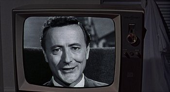 Movie still from “Age of Consent” (1969), directed by Michael Powell – An old television screen with a picture of an older man on it; Close Up shot, Over the shoulder angle