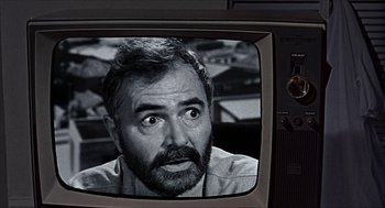 Movie still from “Age of Consent” (1969), directed by Michael Powell – An old tv with a man's face on the screen; Close Up shot, Over the shoulder angle