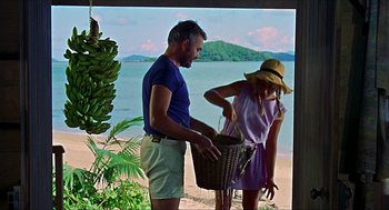 Movie still from “Age of Consent” (1969), directed by Michael Powell – A man and a woman standing next to each other on the beach; Medium shot, Low angle