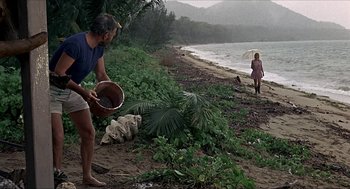 Movie still from “Age of Consent” (1969), directed by Michael Powell – A man and a woman on a beach near the water; Wide shot, High angle