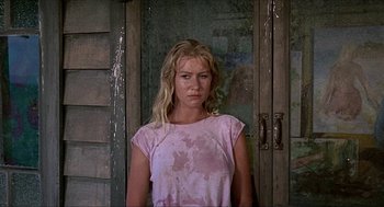 Movie still from “Age of Consent” (1969), directed by Michael Powell – A woman standing in front of an old door; Close Up shot, Low angle