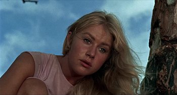 Movie still from “Age of Consent” (1969), directed by Michael Powell – A person with long blonde hair; Close Up shot, Low angle