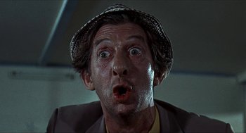 Movie still from “Age of Consent” (1969), directed by Michael Powell – A person wearing a hat; Close Up shot, Low angle