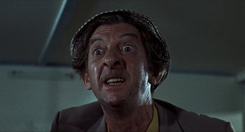 Movie still from “Age of Consent” (1969), directed by Michael Powell – An older man with a hat and a surprised look on his face; Close Up shot, Low angle