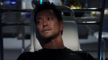 Movie still from “Agents of S.H.I.E.L.D.” (2013), created by Joss Whedon – A person sitting in a chair; Close Up shot, Over the shoulder angle