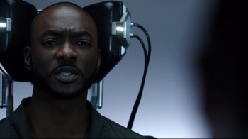 Movie still from “Agents of S.H.I.E.L.D.” (2013), created by Joss Whedon – A black man with a hair dryer in front of him; Close Up shot, Over the shoulder angle