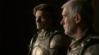 Movie still from “Game of Thrones” (2011), created by D.B. Weiss – A man wearing a suit of armor next to another man; Close Up shot, Over the shoulder angle