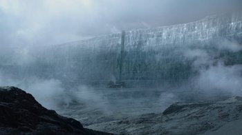Movie still from “Game of Thrones” (2011), created by D.B. Weiss – A truck driving on a road in front of a waterfall; Extreme Wide shot, Low angle