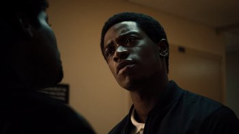 Movie still from “Snowfall” (2017), directed by Hiro Murai – A person looking up at something; Close Up shot, Low angle