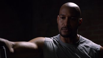 Movie still from “Agents of S.H.I.E.L.D.” (2013), created by Joss Whedon – A man with a beard is looking at the camera; Close Up shot, Over the shoulder angle