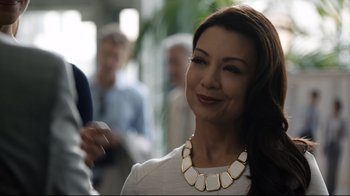 Movie still from “Agents of S.H.I.E.L.D.” (2013), created by Joss Whedon – A woman wearing a gold necklace and a white shirt; Close Up shot, Over the shoulder angle
