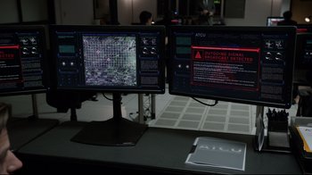 Movie still from “Agents of S.H.I.E.L.D.” (2013), created by Joss Whedon – Two computer monitors on top of a desk; Extreme Close Up shot, Overhead angle