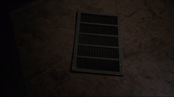 Movie still from “Agents of S.H.I.E.L.D.” (2013), created by Joss Whedon – An air vent on the floor of a dark room; Extreme Close Up shot, Overhead angle
