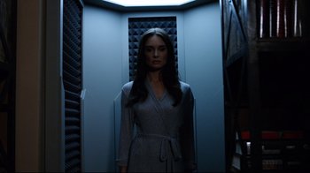 Movie still from “Agents of S.H.I.E.L.D.” (2013), created by Joss Whedon – A woman standing in front of an elevator in the dark; Medium shot, Low angle