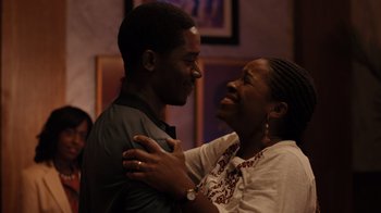 Movie still from “Snowfall” (2017), directed by Hiro Murai – A man and a woman are smiling and hugging; Medium shot, Over the shoulder angle