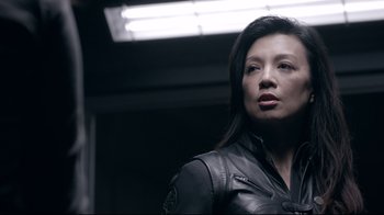 Movie still from “Agents of S.H.I.E.L.D.” (2013), created by Joss Whedon – A woman in a leather jacket looking to her left; Close Up shot, Low angle