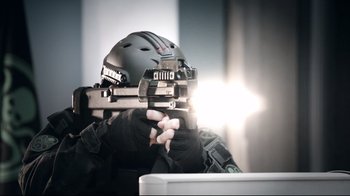 Movie still from “Agents of S.H.I.E.L.D.” (2013), created by Joss Whedon – A man holding a gun and wearing a helmet; Close Up shot, Low angle