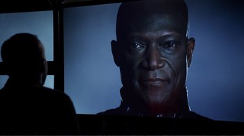 Movie still from “Agents of S.H.I.E.L.D.” (2013), created by Joss Whedon – A man is looking at a television screen; Close Up shot, Over the shoulder angle