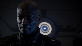 Movie still from “Agents of S.H.I.E.L.D.” (2013), created by Joss Whedon – A man in a black jacket is looking at the camera; Close Up shot, Over the shoulder angle