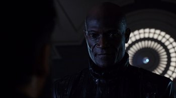 Movie still from “Agents of S.H.I.E.L.D.” (2013), created by Joss Whedon – A man in a leather jacket looking at the camera; Close Up shot, Over the shoulder angle