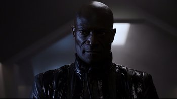 Movie still from “Agents of S.H.I.E.L.D.” (2013), created by Joss Whedon – A man in a black leather jacket looking at the camera; Close Up shot, Low angle