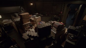 Movie still from “Agents of S.H.I.E.L.D.” (2013), created by Joss Whedon – A cluttered room filled with lots of books and boxes; Wide shot, High angle