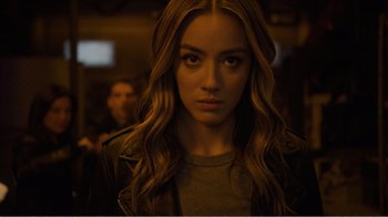 Movie still from “Agents of S.H.I.E.L.D.” (2013), created by Joss Whedon – A person with long brown hair; Close Up shot, Over the shoulder angle