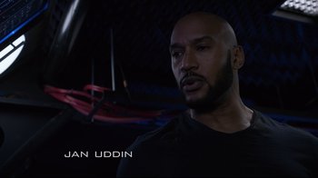 Movie still from “Agents of S.H.I.E.L.D.” (2013), created by Joss Whedon – A man with a bald head is looking at the camera; Close Up shot, Low angle