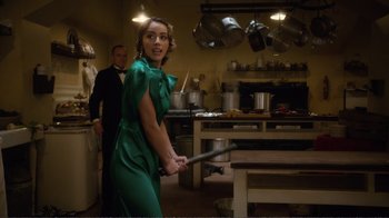 Movie still from “Agents of S.H.I.E.L.D.” (2013), created by Joss Whedon – A woman holding a baseball bat in a kitchen; Medium shot, Over the shoulder angle