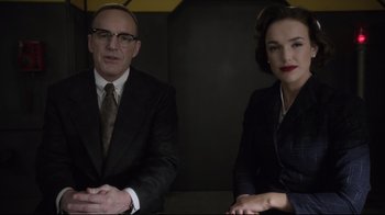 Movie still from “Agents of S.H.I.E.L.D.” (2013), created by Joss Whedon – A man and a woman sitting next to each other; Medium shot, Over the shoulder angle