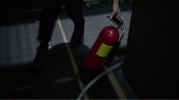 Movie still from “Agents of S.H.I.E.L.D.” (2013), created by Joss Whedon – A fire extinguisher is being held by a person; Extreme Close Up shot, High angle