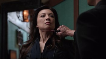 Movie still from “Agents of S.H.I.E.L.D.” (2013), created by Joss Whedon – A woman getting her hair cut by a stylist; Close Up shot, Over the shoulder angle