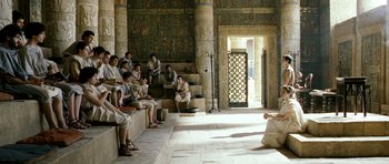 Movie still from “Agora” (2009), directed by Alejandro Amenábar – A group of people sitting on steps in front of a building; Extreme Wide shot, High angle