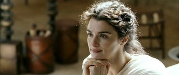 Movie still from “Agora” (2009), directed by Alejandro Amenábar – A beautiful woman sitting down with her hands under her chin; Close Up shot, Over the shoulder angle