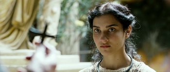 Movie still from “Agora” (2009), directed by Alejandro Amenábar – A person wearing glasses and looking at the camera; Close Up shot, Over the shoulder angle