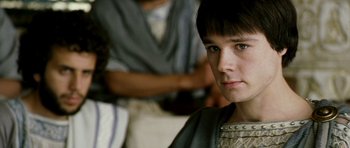 Movie still from “Agora” (2009), directed by Alejandro Amenábar – A young man in roman garb looking into the camera; Close Up shot, Over the shoulder angle