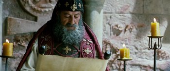 Movie still from “Agora” (2009), directed by Alejandro Amenábar – An old man with a long beard wearing a red and black outfit; Close Up shot, Low angle