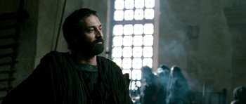 Movie still from “Agora” (2009), directed by Alejandro Amenábar – A man with a long beard is standing in front of a window; Close Up shot, Low angle