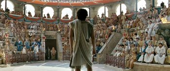 Movie still from “Agora” (2009), directed by Alejandro Amenábar – A man wearing a toga standing in front of a crowd of people; Extreme Wide shot, High angle