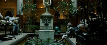 Movie still from “Agora” (2009), directed by Alejandro Amenábar – An old man sitting on a bench next to a statue; Wide shot, High angle