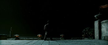 Movie still from “Agora” (2009), directed by Alejandro Amenábar – A man standing in front of a black wall; Extreme Wide shot, Low angle