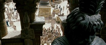 Movie still from “Agora” (2009), directed by Alejandro Amenábar – A group of people gathered around a statue; Extreme Wide shot, High angle