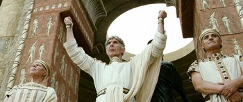 Movie still from “Agora” (2009), directed by Alejandro Amenábar – An older man in a roman outfit raises his hands; Medium shot, Low angle