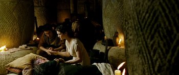 Movie still from “Agora” (2009), directed by Alejandro Amenábar – A group of people sitting in a room with candles; Medium shot, High angle