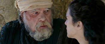 Movie still from “Agora” (2009), directed by Alejandro Amenábar – An old man and a young woman looking at each other; Close Up shot, Over the shoulder angle
